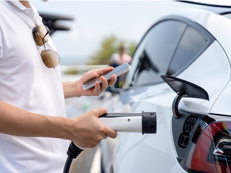 Car Owner Charging Electric Vehicle